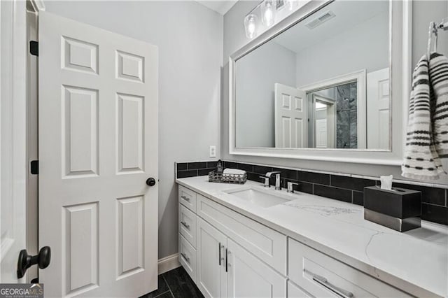 bathroom with vanity and decorative backsplash