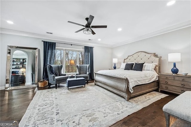 bedroom with ornamental molding, dark hardwood / wood-style floors, and ceiling fan