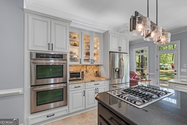 9135 Etching Overlook, Johns Creek, GA 30097 - kitchen featuring appliances with stainless steel finishes, ornamental molding, dark stone counters, and white cabinets