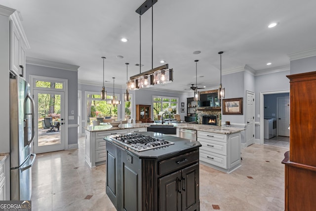 9135 Etching Overlook, Johns Creek, GA 30097 - kitchen with stainless steel appliances, washer and dryer, a large island, a ceiling fan, and recessed lighting