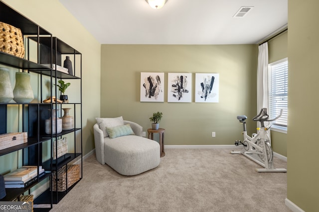 sitting room featuring light colored carpet