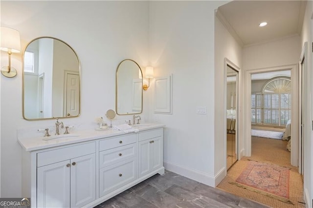 bathroom with ornamental molding and vanity