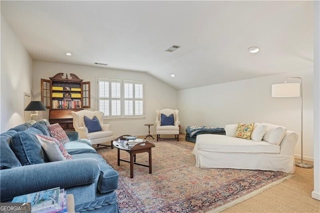 carpeted living room featuring vaulted ceiling