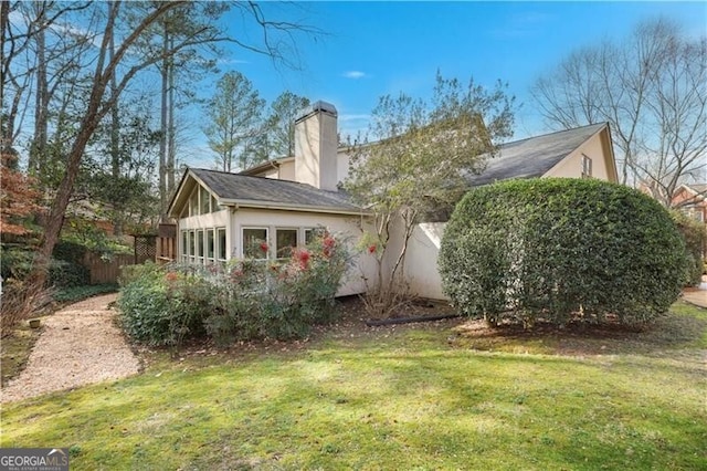 view of side of property featuring a lawn