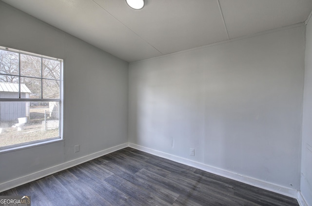 spare room featuring dark wood-type flooring