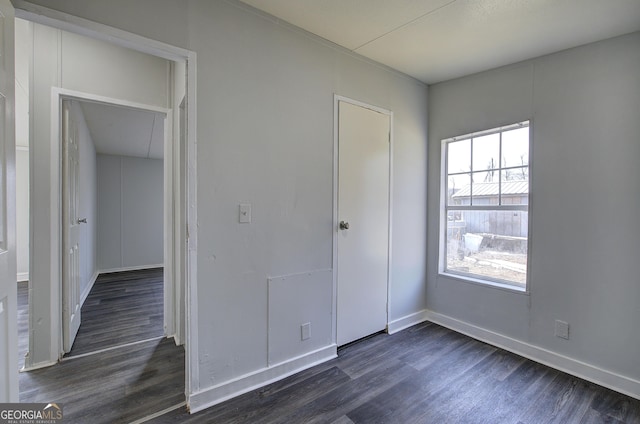 unfurnished bedroom with dark wood-type flooring