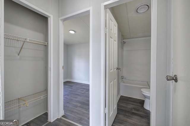 bathroom featuring hardwood / wood-style flooring and toilet