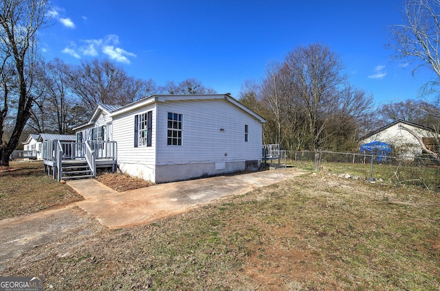 view of home's exterior featuring a wooden deck and a yard