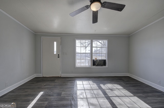 foyer featuring ornamental molding, dark wood-type flooring, and ceiling fan