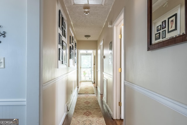 hallway with a textured ceiling