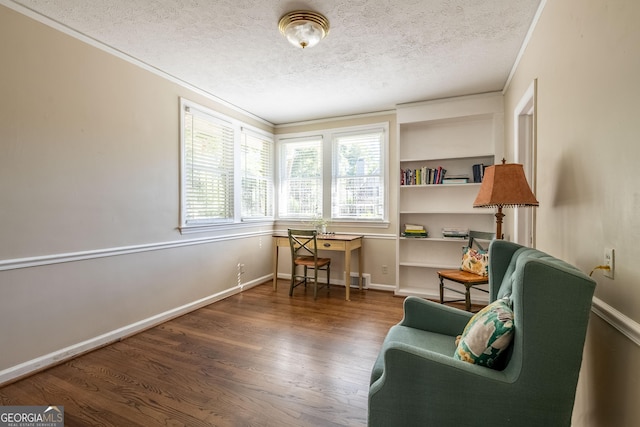 living area featuring ornamental molding, hardwood / wood-style floors, and a textured ceiling