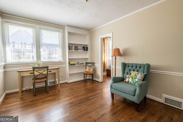 sitting room featuring crown molding, hardwood / wood-style floors, and a textured ceiling