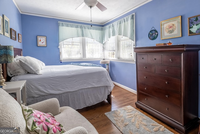 bedroom with ceiling fan, ornamental molding, and dark hardwood / wood-style flooring