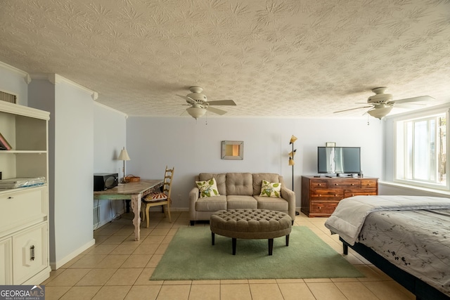 tiled bedroom featuring crown molding, ceiling fan, and a textured ceiling