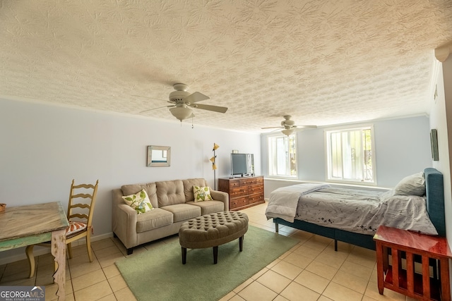 bedroom featuring light tile patterned flooring, crown molding, ceiling fan, and a textured ceiling