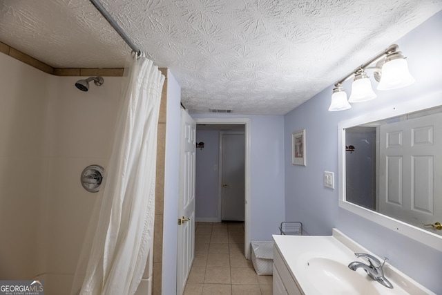 bathroom featuring vanity, a shower with curtain, tile patterned floors, and a textured ceiling