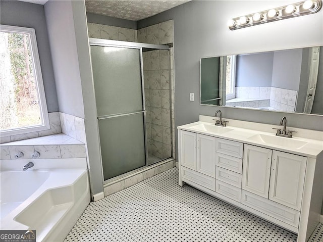 bathroom featuring vanity and independent shower and bath