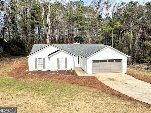 single story home featuring a garage and a front yard