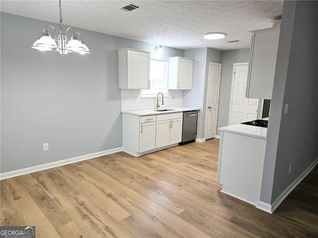 kitchen featuring sink, white cabinetry, tasteful backsplash, hanging light fixtures, and dishwasher