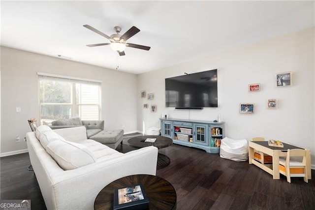 living room featuring dark wood-type flooring and ceiling fan