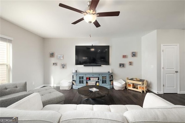 living room featuring ceiling fan and dark hardwood / wood-style flooring