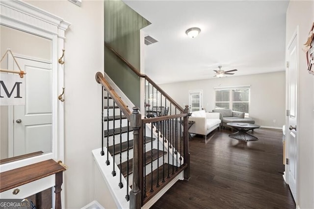 stairway featuring hardwood / wood-style flooring and ceiling fan