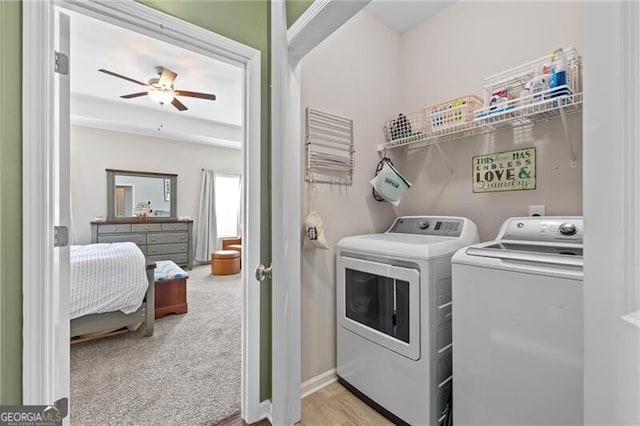 laundry room with ceiling fan, light carpet, and independent washer and dryer