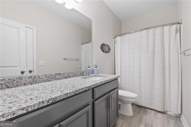 bathroom with vanity, hardwood / wood-style floors, and toilet