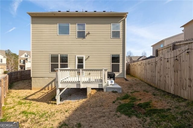 rear view of property featuring a wooden deck