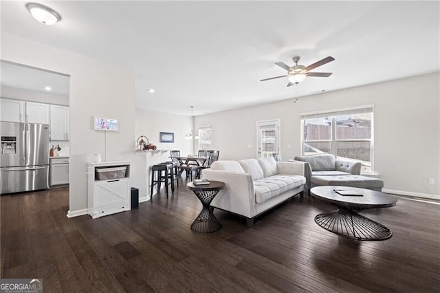 living room with dark hardwood / wood-style floors and ceiling fan