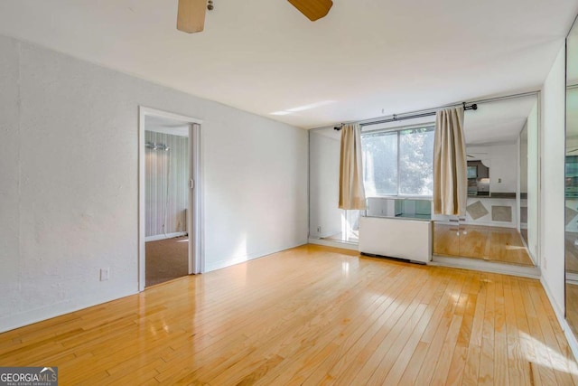 spare room with ceiling fan and light hardwood / wood-style floors