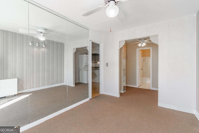 unfurnished bedroom featuring carpet, ceiling fan, and a closet