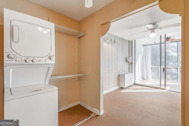 washroom featuring stacked washer and dryer, carpet floors, and ceiling fan