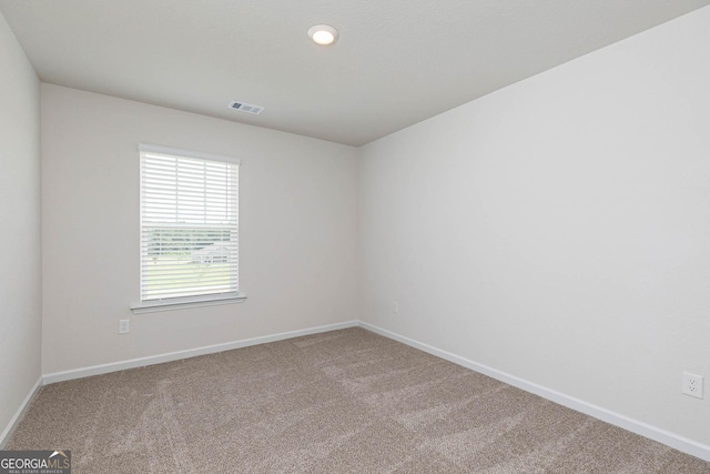 unfurnished room featuring carpet flooring