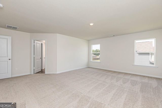 spare room with light carpet