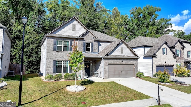 view of front facade with driveway, a garage, a front yard, central AC, and brick siding