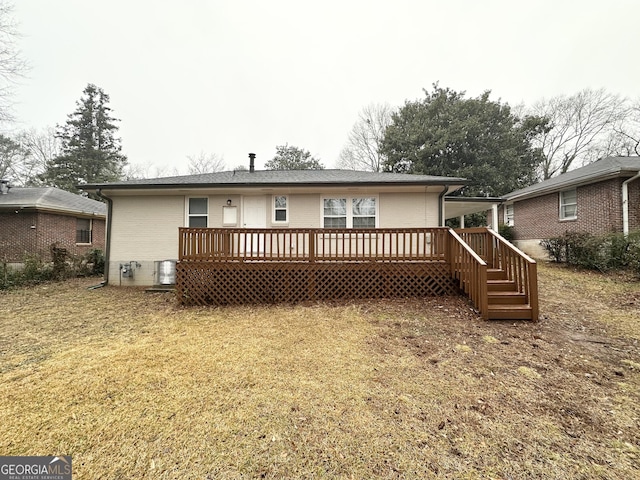 rear view of property featuring a yard, a deck, and central air condition unit