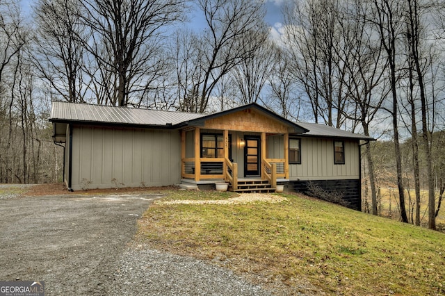 ranch-style house with covered porch and a front lawn