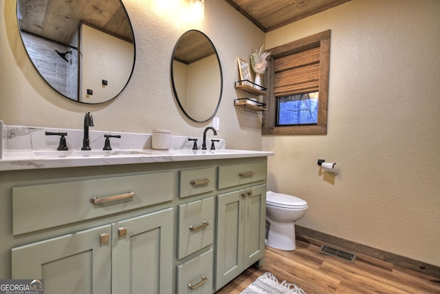 bathroom with hardwood / wood-style flooring, vanity, and toilet