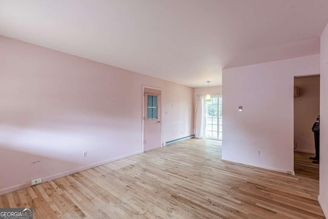 unfurnished room featuring light hardwood / wood-style flooring and baseboard heating