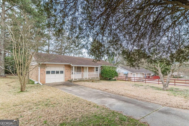 ranch-style house with a garage and a front lawn