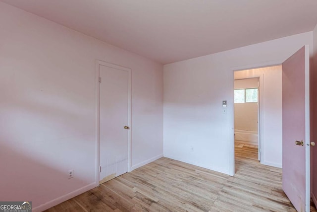 unfurnished room with light wood-type flooring