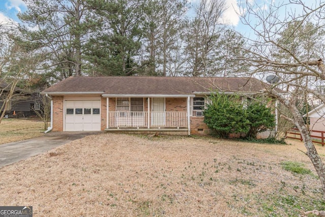 single story home featuring a porch, a garage, and a front yard