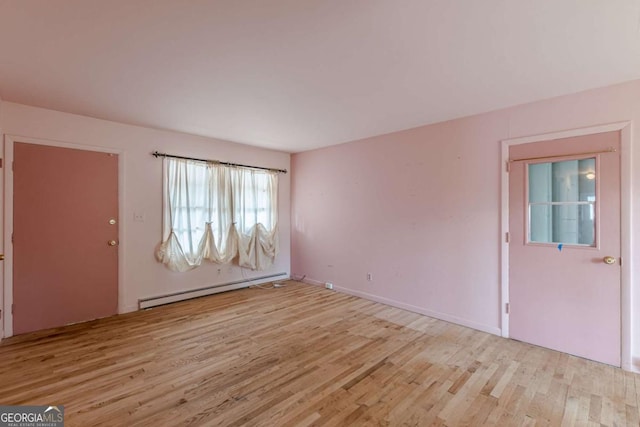 interior space with light hardwood / wood-style flooring and baseboard heating