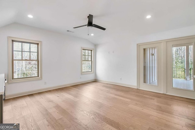 empty room with light hardwood / wood-style flooring, vaulted ceiling, and ceiling fan