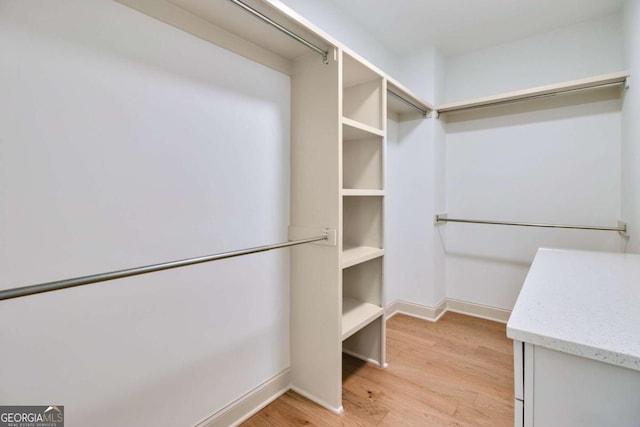 spacious closet with light hardwood / wood-style floors