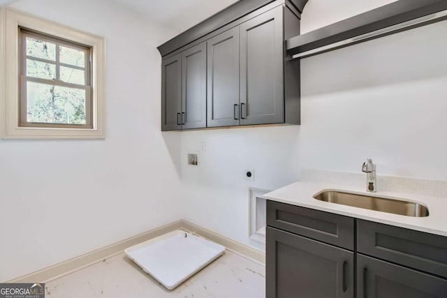 clothes washing area featuring hookup for a washing machine, sink, hookup for an electric dryer, and cabinets