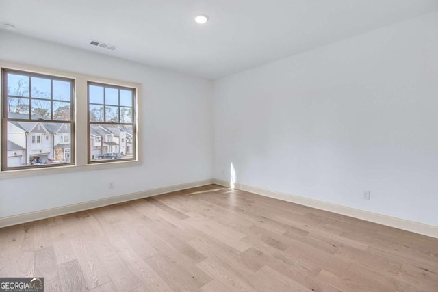 unfurnished room with light wood-type flooring