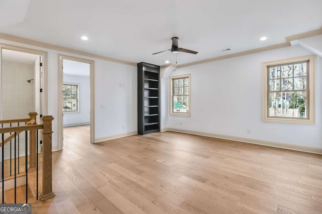 empty room with ceiling fan and light wood-type flooring