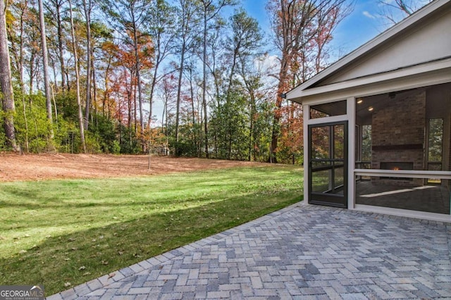 view of yard featuring a patio and a sunroom